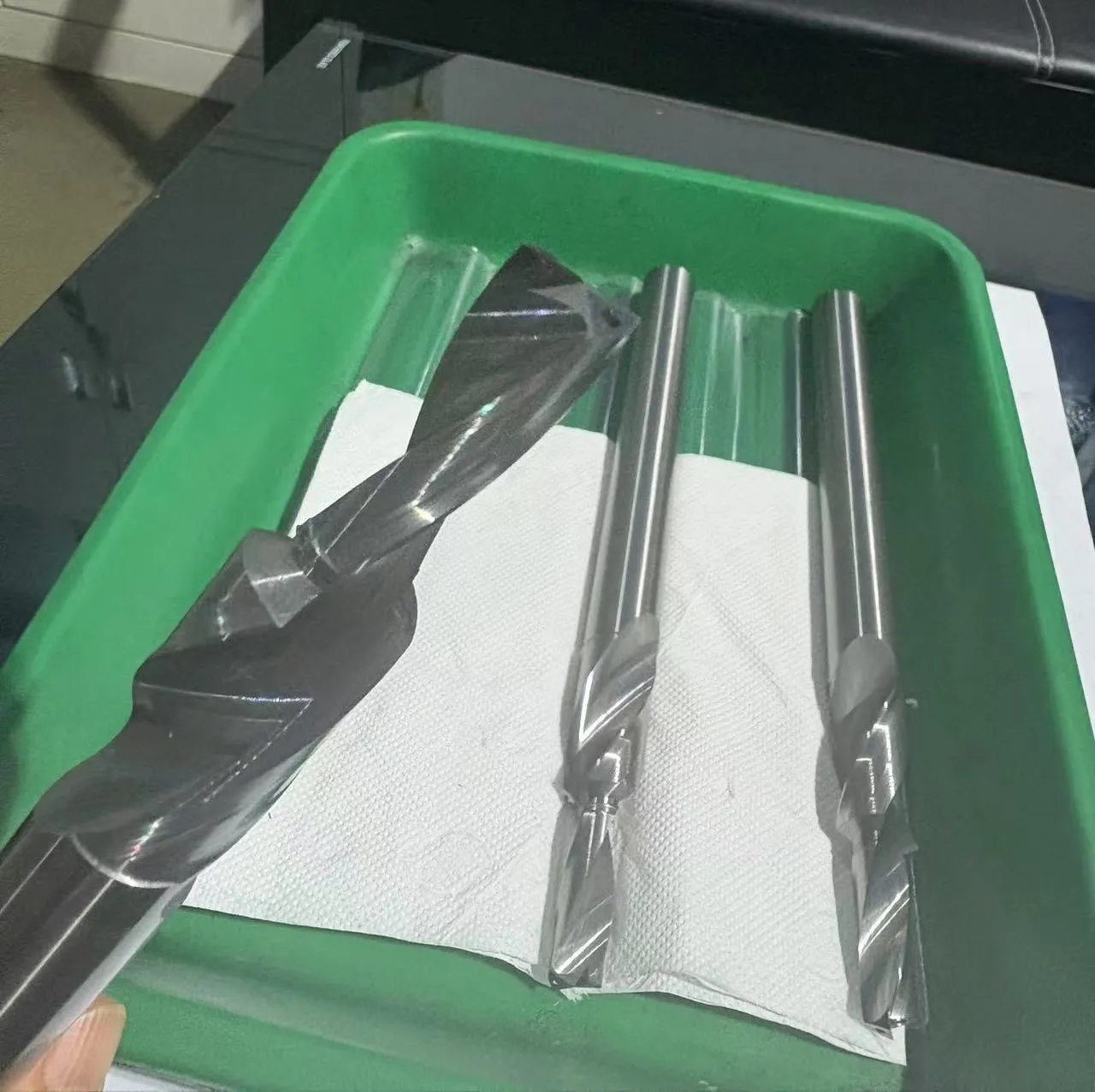 Flat bottom stepped coolant inside solid carbide drills, photographed in the workshop before coating